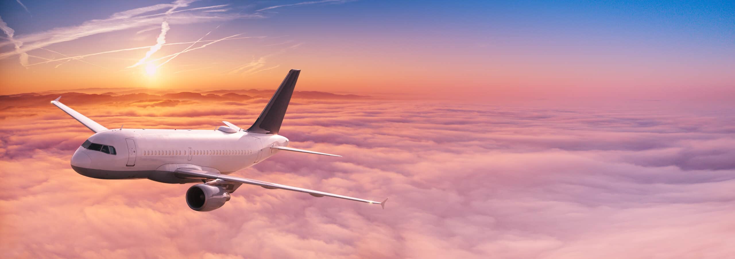 Commercial,Airplane,Jetliner,Flying,Above,Dramatic,Clouds,In,Beautiful,Sunset