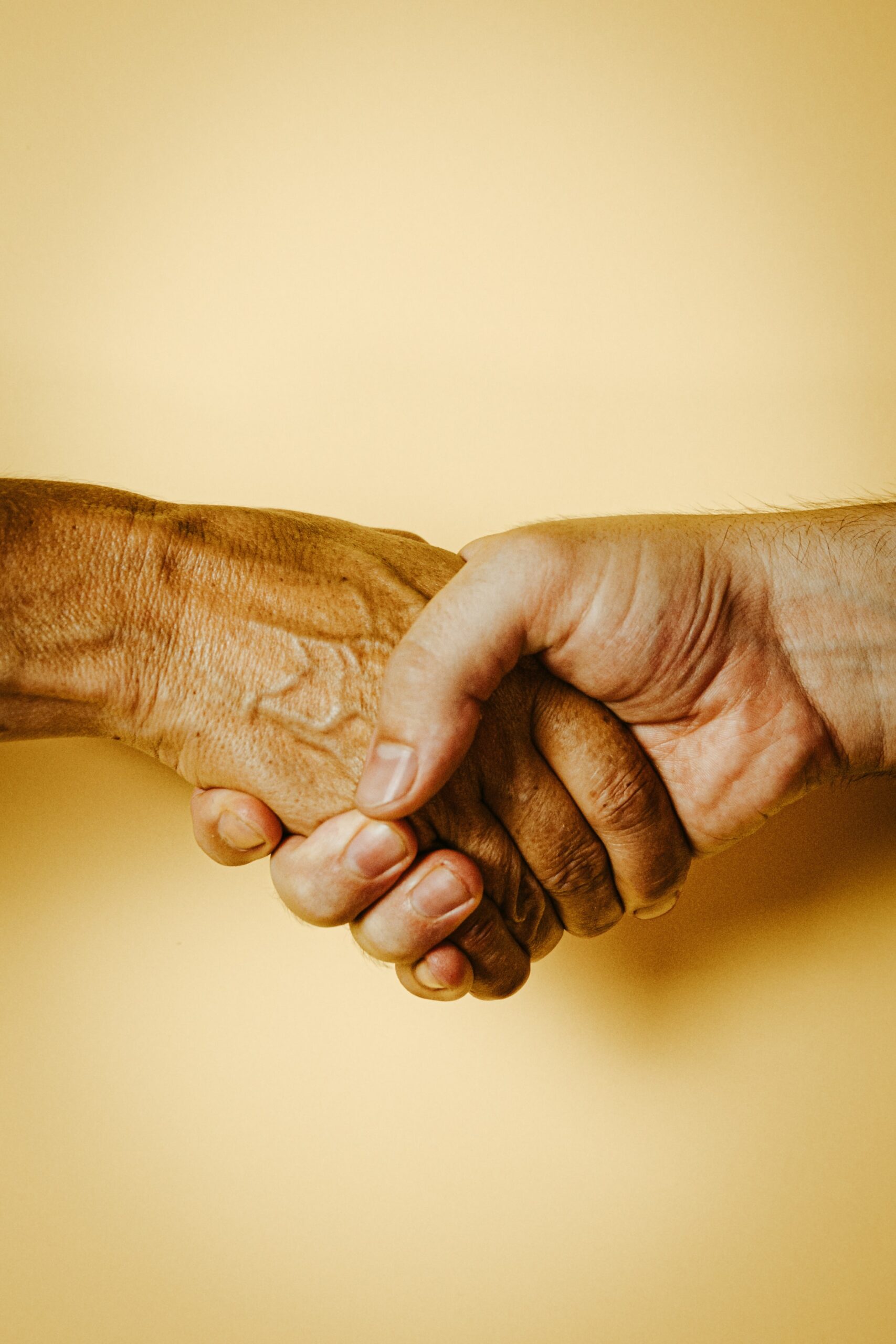 Holding Hands clasped together Photo by Ave Calvar